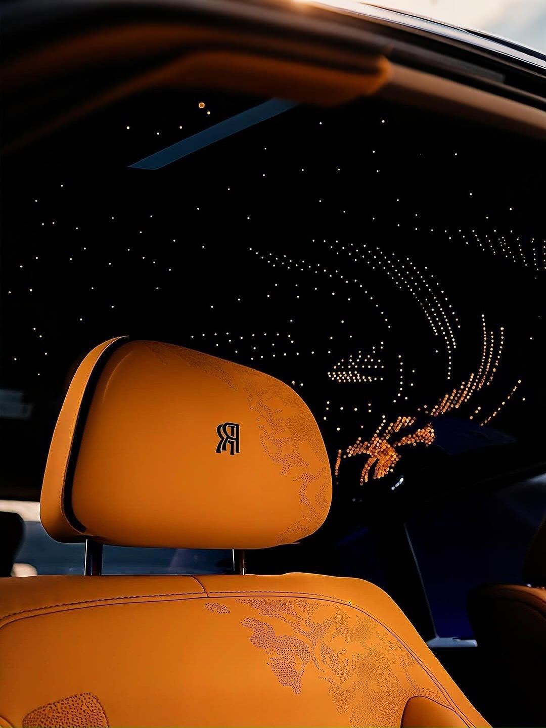 Gold leather seat beneath a starlight car roof